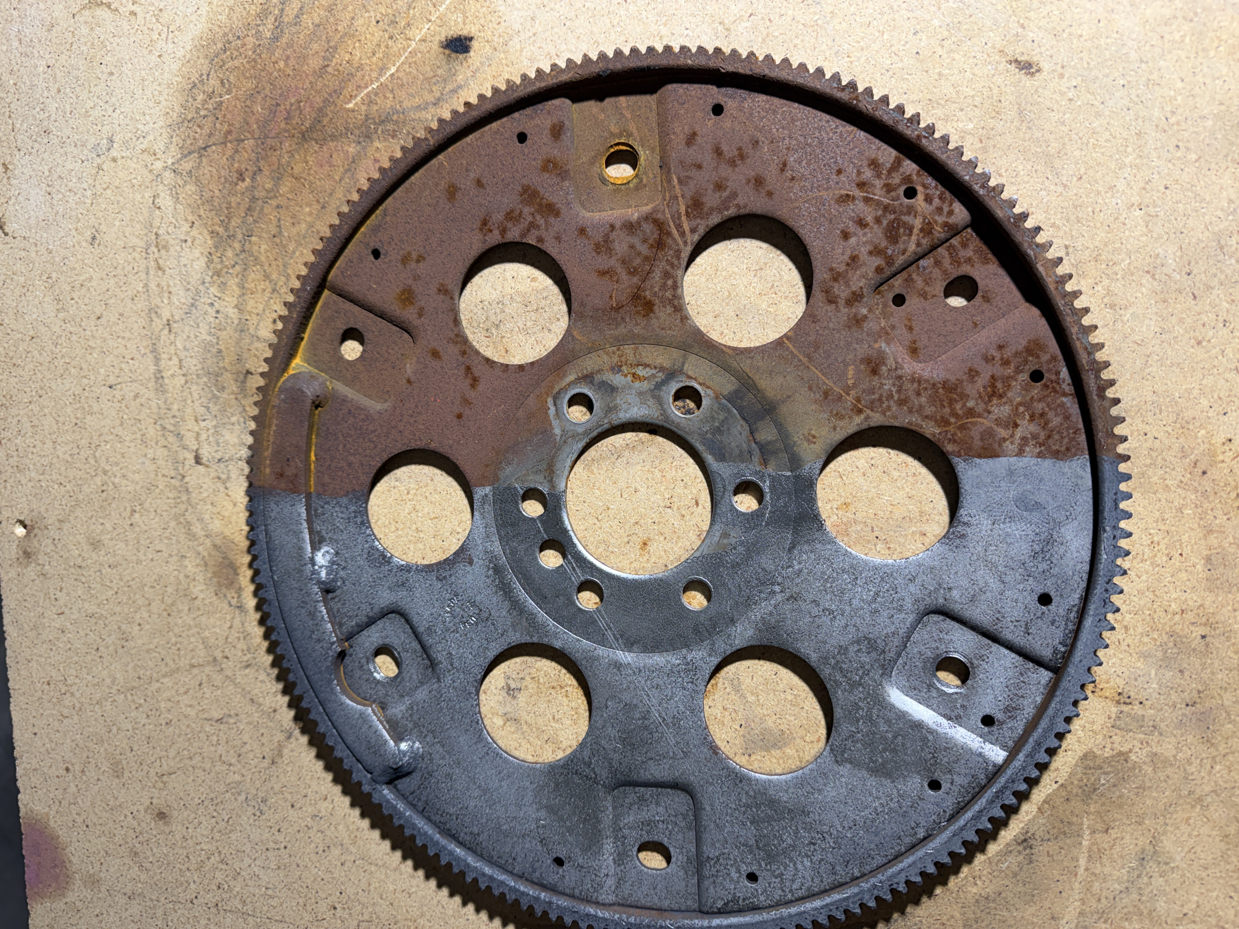Automotive flex plate showing half cleaned and half uncleaned comparison from laser cleaning
