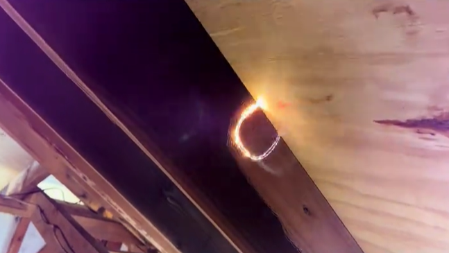 Residential ceiling beam during soot removal with laser cleaning