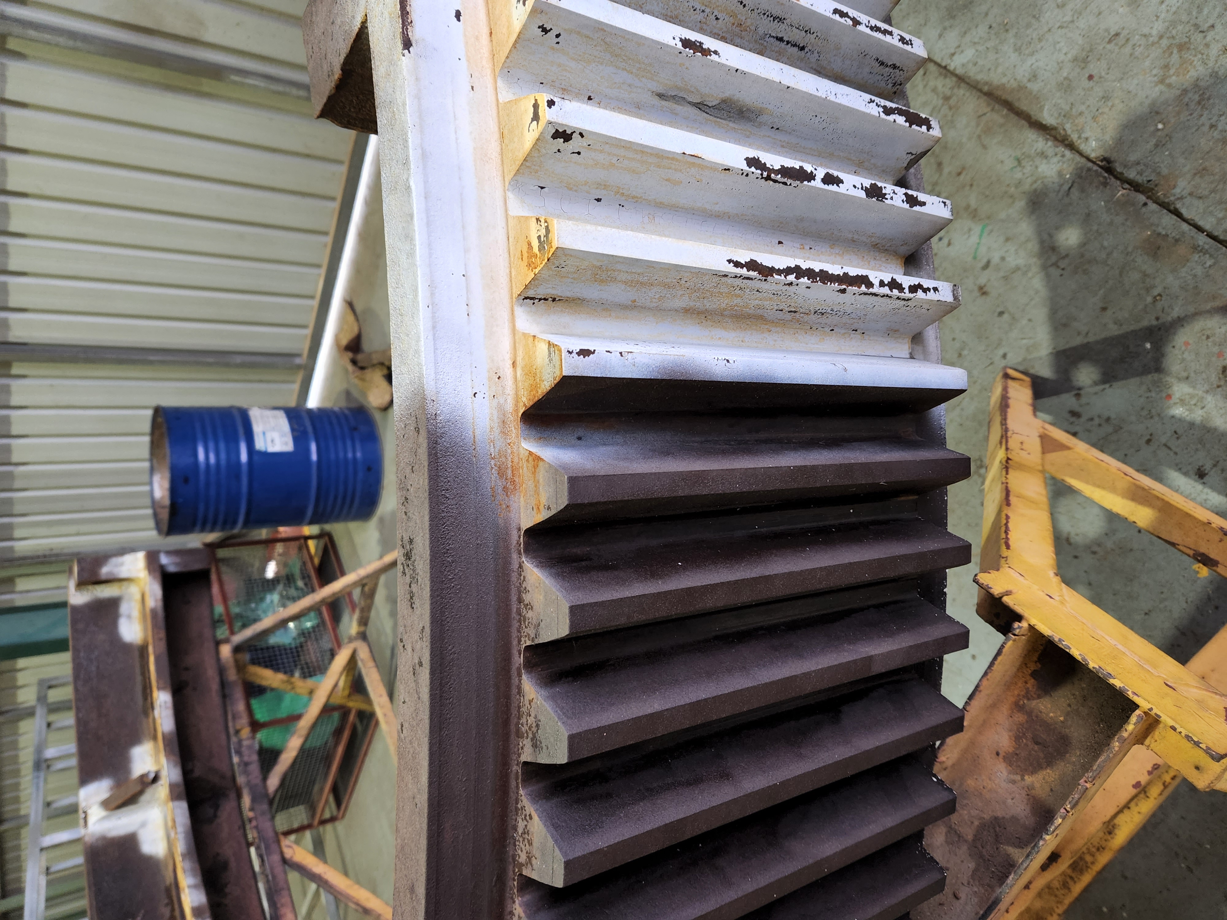 Industrial gear showing half cleaned and half uncleaned surface during laser cleaning