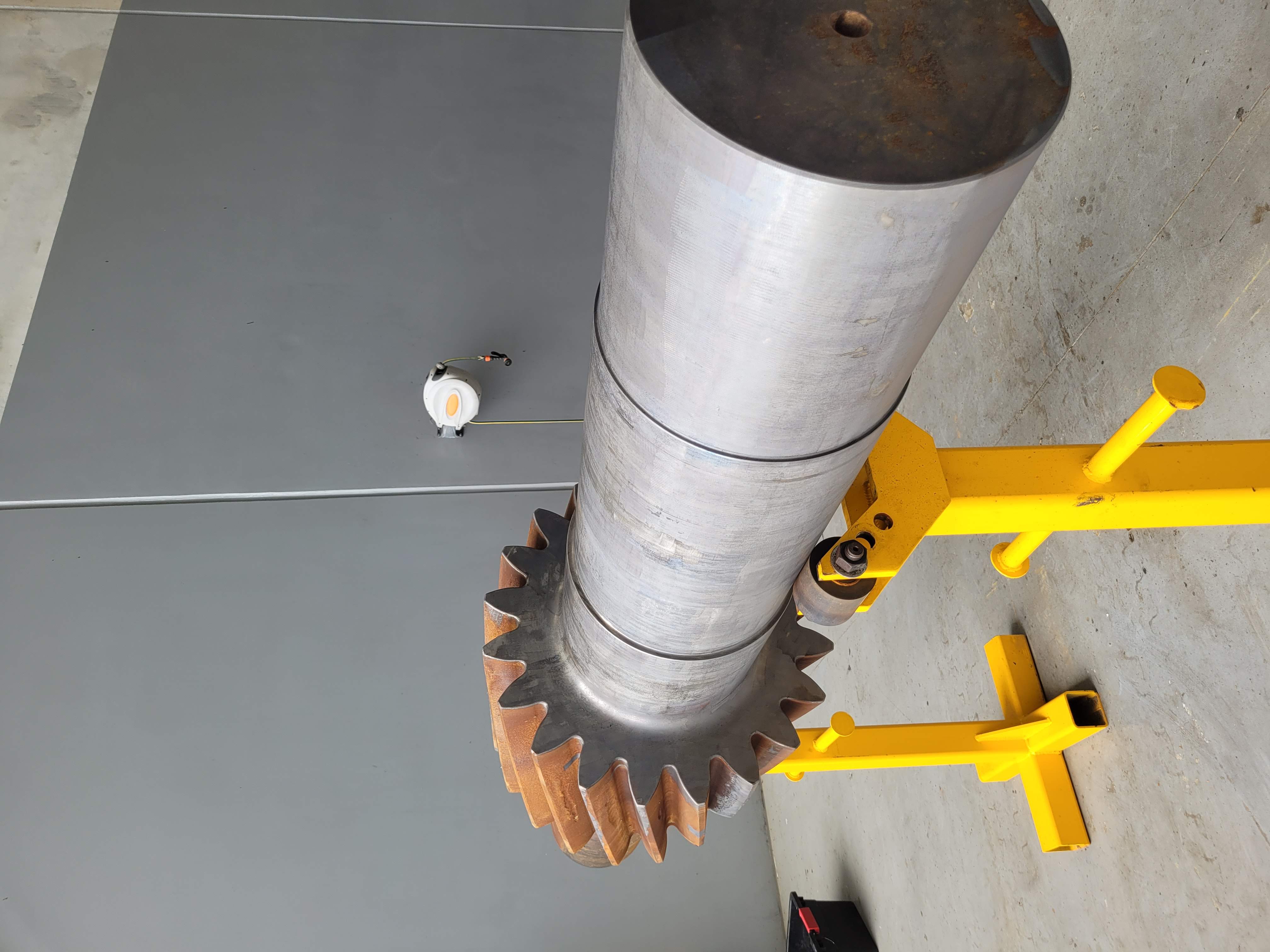 Industrial pinion shaft with heavy rust and contamination before laser cleaning