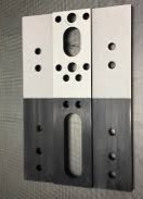 Tooling piece showing half with coating and half stripped clean by laser