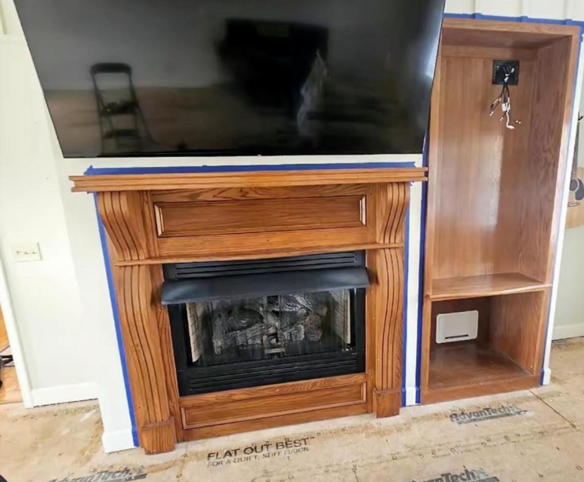 Stone fireplace surround with soot and smoke staining before laser cleaning