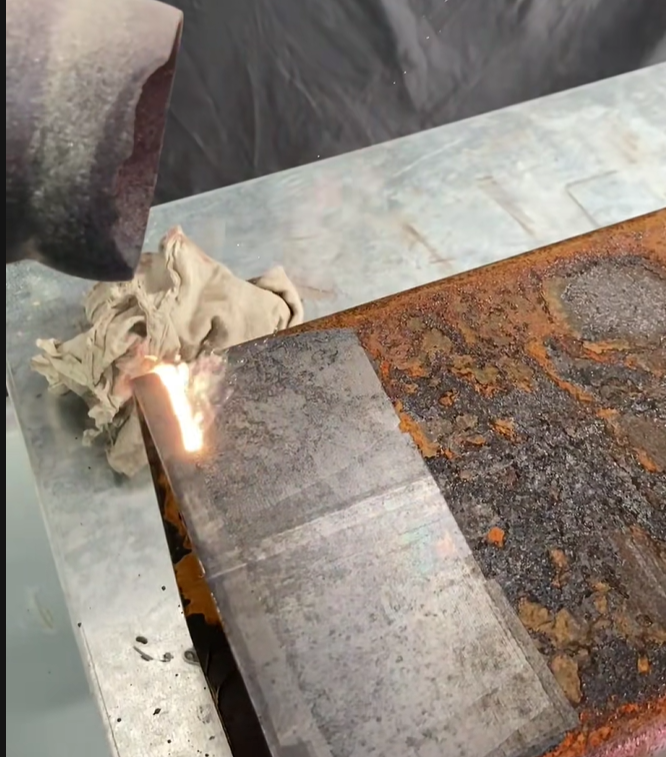 Rusty metal surface being restored with laser cleaning