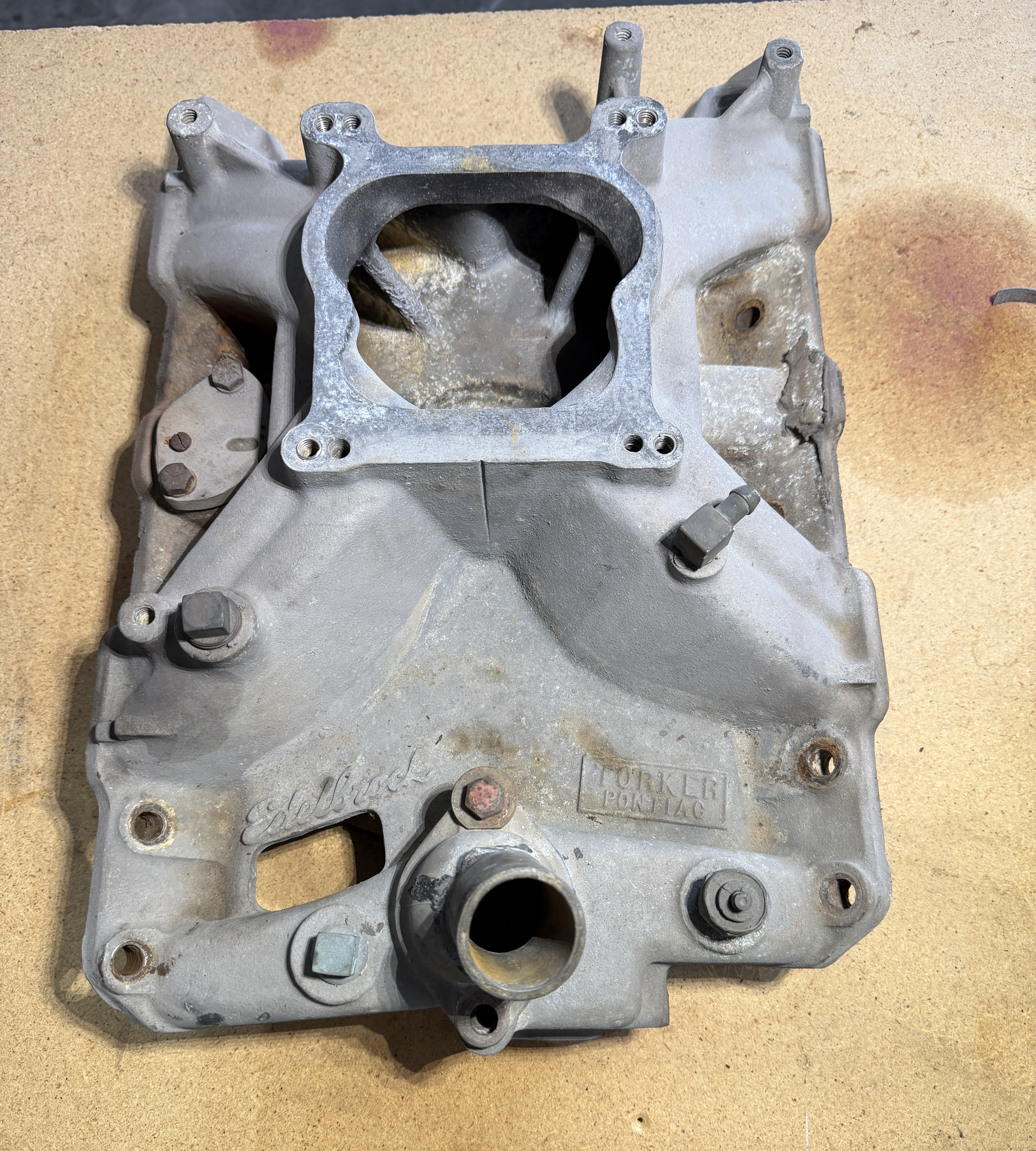Aluminum intake manifold with gasket material and carbon buildup