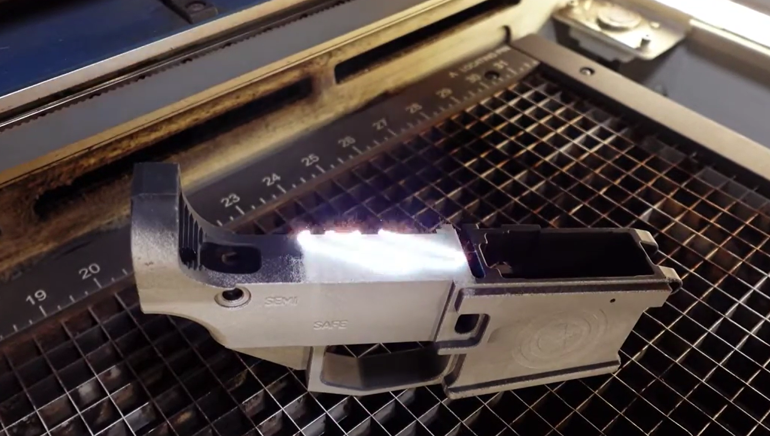 Firearm component detail showing original finish and tolerances preserved through laser cleaning