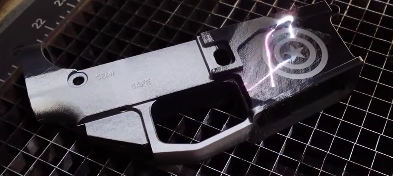 Firearm component during laser cleaning with carbon fouling and surface contamination removed